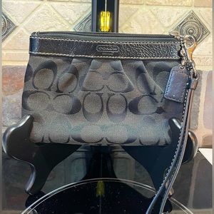 Black Coach Classic Monogram Wristlet with red interior
In excellent condition